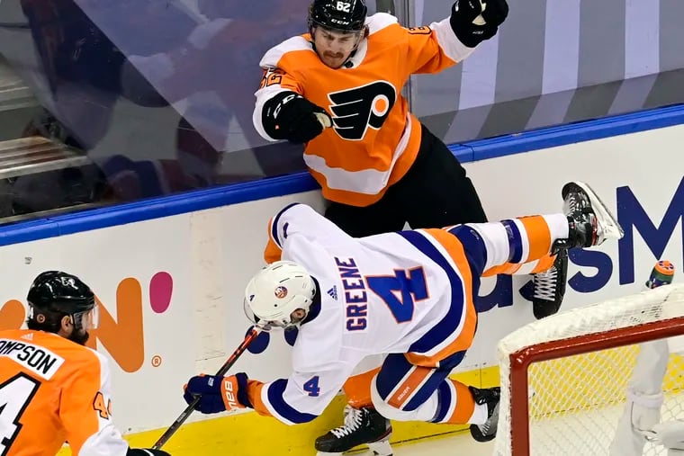 Flyers right wing Nicolas Aube-Kubel (62) checks New York Islanders defenseman Andy Greene  behind the net during the first period of Game 7.
