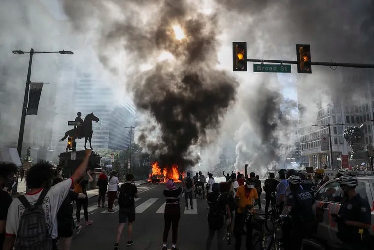Protesters cheered while a police vehicle was set on fire outside of City Hall in Center City Philadelphia on Saturday during protests over the death of George Floyd.