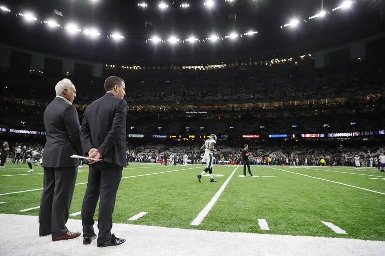 Eagles owner Jeffrey Lurie, left, and executive vice president of football operations Howie Roseman watching from the sideline before the Eagles played the Saints in the playoffs in January.