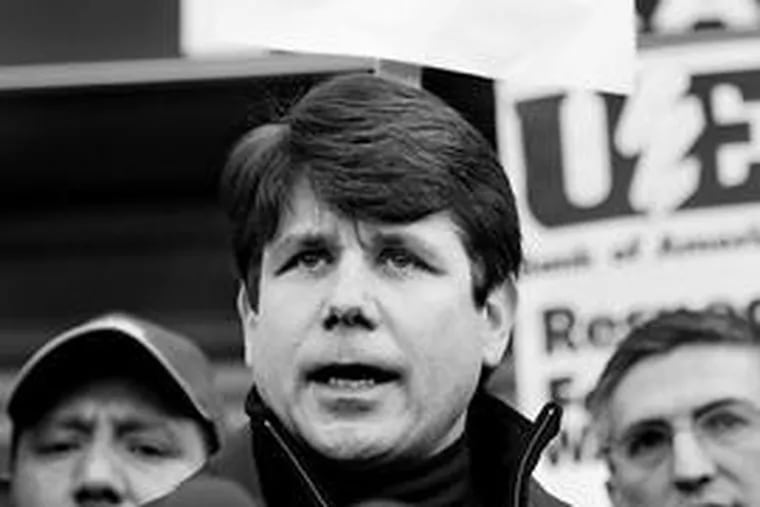 Illinois Gov. Rod Blagojevich stands with workers on the fourth day of a sit-in at Republic Windows & Doors Inc., of Chicago.