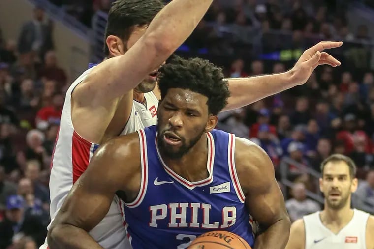 Joel Embiid drives in on Detroit's Zaza Pachulia during the second quarter of the Sixers' 116-102 win over the Pistons Monday at the Wells Fargo Center.