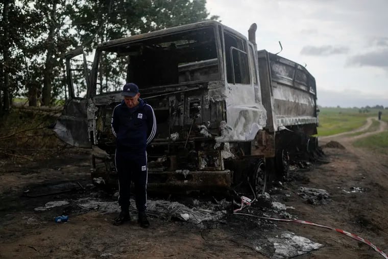 Vadym Schvydchenko stands next to his truck that recently was damaged by a mine on a dirt track near Makariv, on the outskirts of Kyiv, Ukraine.
