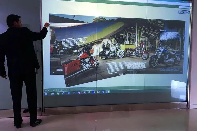 Project developer Michael Holbert demonstrates a supersized smart screen fabricated locally and targeted to meeting room needs.