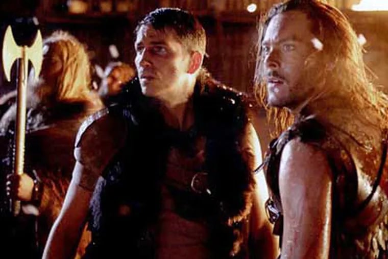 Kainan (James Caviezel, center), who crash-landed his UFO on Earth, is joined by the Viking Wulfric (Jack Huston, right).