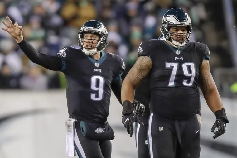 Eagles quarterback Nick Foles signals with offensive guard Brandon Brooks against the Oakland Raiders on Monday, December 25, 2017 in Philadelphia.
