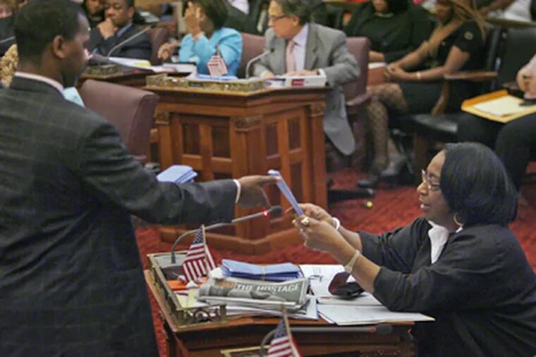 Councilwoman Marian Tasco, who wants to save the deferred retirement program known as DROP, hands off her bills and resolutions. (Alejandro A. Alvarez / Staff Photographer)