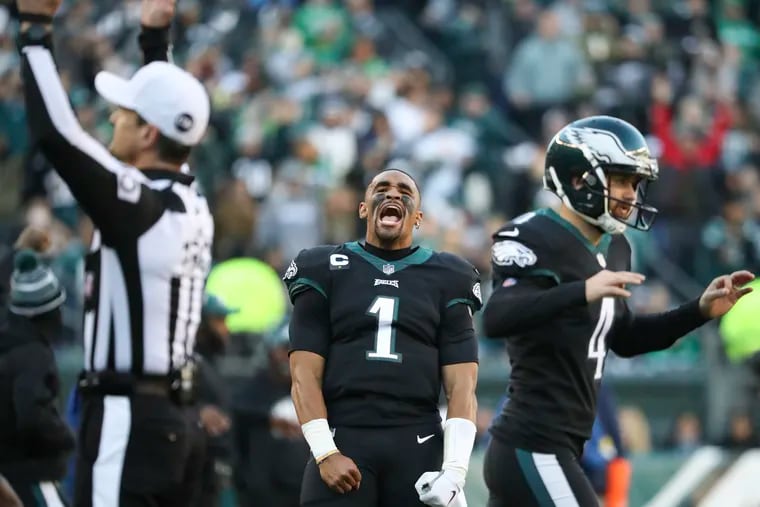 Eagles quarterback Jalen Hurts yells after officials ruled wide receiver DeVonta Smith did catch a third quarter touchdown against the New York Giants on Sunday, December 26, 2021 in Philadelphia.  Game officials overturned the original review that the touchdown did not count.
