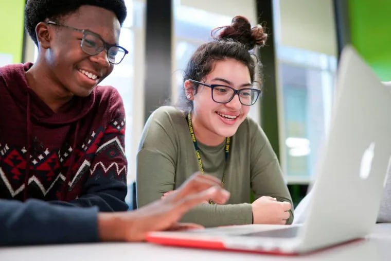An image provided by Apple shows students at Chicago's Lane Tech College Prep High School learning to build apps using Swift, Apple's programming language.