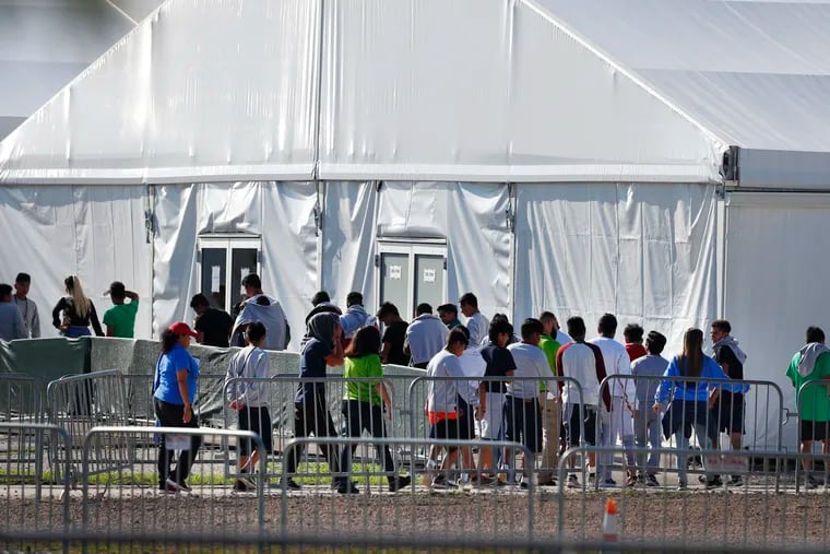 In this Feb. 19, 2019, photo, children line up to enter a tent at the Homestead Temporary Shelter for Unaccompanied Children in Homestead, Fla.