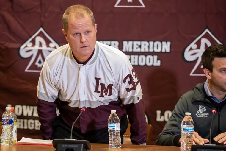 Lower Merion head basketball coach Gregg Downer wears Kobe Bryant's old No. 33 warm-up jacket during a news conference on Tuesday.