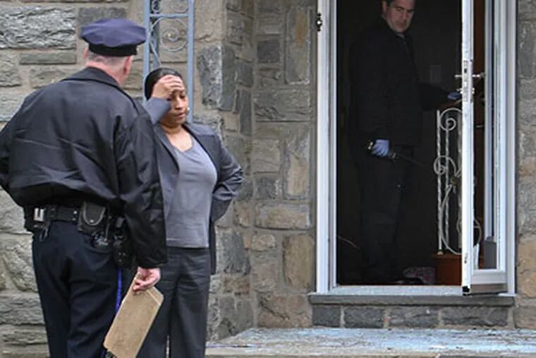 A woman, believed to be the home owner, speaks with police outside the house at 1740 Hoffnagle St. in the city's Rhawnhurst section on Thursday, where an off-duty Philadelphia Fire Marshall shot a female intruder in the doorway. (For the Daily News / Joseph Kaczmarek)