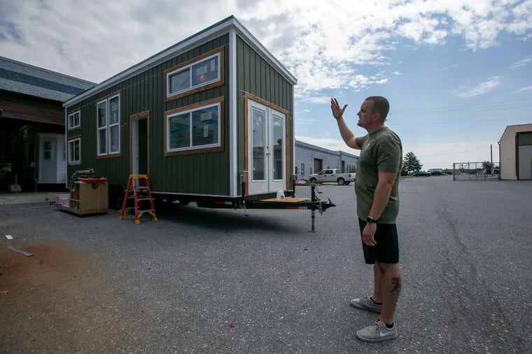 Marcus Stoltzfus, co-owner of Liberation Tiny Homes in Leola, Pa., shows off a model similar to the kind being considered to house people experiencing homelessness in Philadelphia.