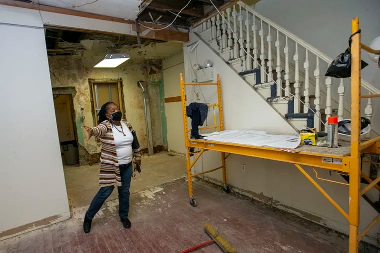 Kay Johnson, with Miriam Medical Clinics Inc., gives a tour of a rowhouse in the Point Breeze section of Philadelphia that is being renovated to provide medical attention to uninsured or underinsured patients of color.