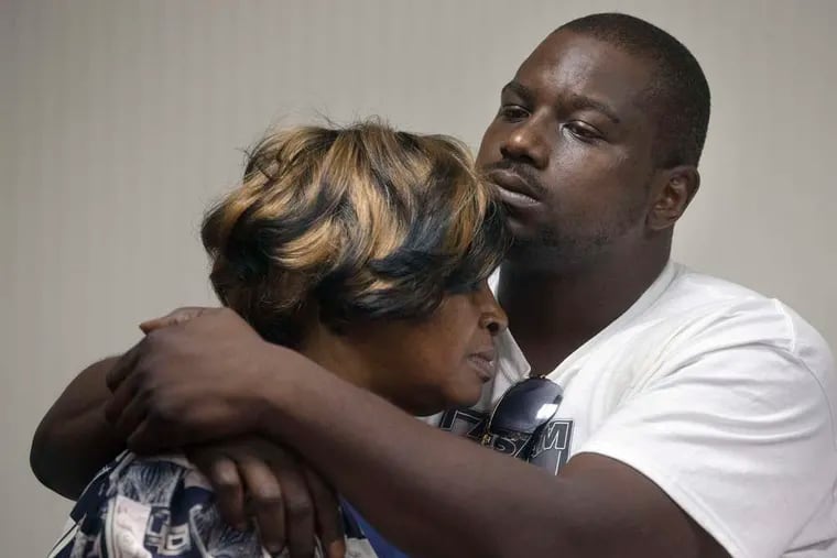 Aubrey DuBose embraces his mother, Audrey, after charges were announced in the death of their brother and son, Samuel.