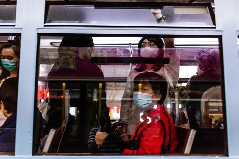 Passengers on a tram wear surgical masks on Jan. 24, 2020, in Hong Kong, China. A woman in Chicago who traveled to China earlier this month has been diagnosed with coronavirus. (Willie Siau/SOPA Images/Zuma Press/TNS)
