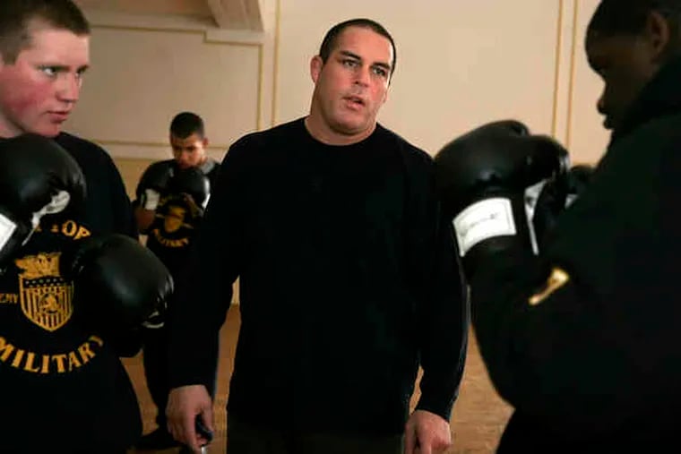Damon Feldman (center), conducting a boxing clinic at Valley Forge Military Academy in 2007, is accused of promoting without a license and fixing bouts.