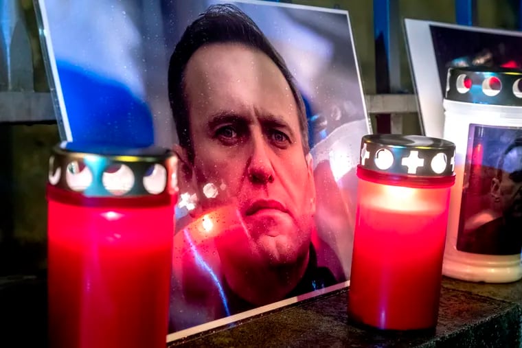 Candles and a photo of jailed Russian opposition leader Alexei Navalny, who has died in a Russian prison, according to the Federal Penitentiary Service, are placed at the fence of the meanwhile closed Russian consulate in Frankfurt, Germany, on Friday.