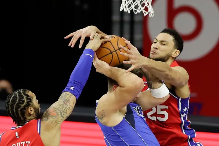 Sixers guard Ben Simmons and forward Mike Scott put the clamps on Mavericks star Luka Doncic during the second quarter.