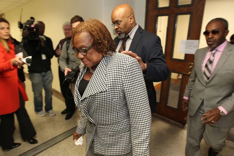 State Sen. LeAnna Washington (center) leaves court in Norristown on Thursday after being sentenced to three months of house arrest and 57 months of probation. She was also ordered to pay $200,000 in restitution.
