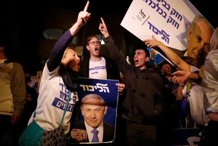 Supporters of Israeli Prime Minister Benjamin Netanyahu gather outside his residence in Jerusalem, Thursday, Nov. 21, 2019. Israel's attorney general charged Netanyahu with fraud, breach of trust and accepting bribes in three different scandals. It is the first time a sitting Israeli prime minister has been charged with a crime.