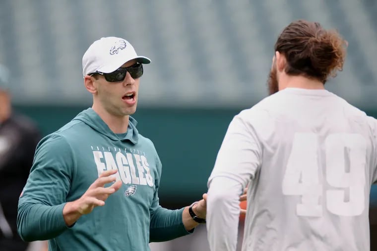Eagles defensive coordinator Jonathan Gannon, pictured talking to linebacker Alex Singleton during OTAs in June, has placed an emphasis on forcing turnovers.