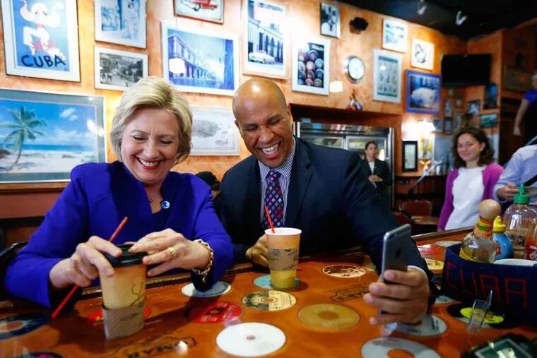 Democratic presidential candidate Hillary Clinton and Sen. Cory Booker, D-N.J., on the campaign trail. She says he “has more energy and charisma than anybody else I know.”