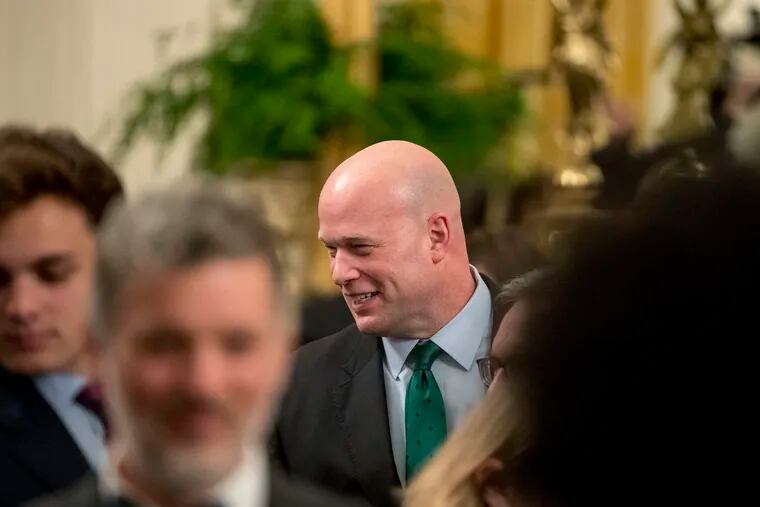 Acting United States Attorney General Matt Whitaker, center, departs following a Medal of Freedom ceremony in the East Room of the White House in Washington, Friday, Nov. 16, 2018.