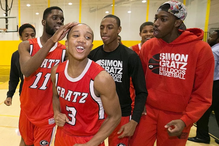 Gratz's Tyriek Meridith and his teammates celebrate after their 60-55 victory over Archbishop Ryan.