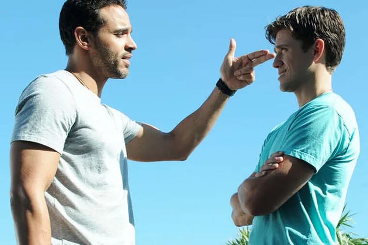 Daniel Sunjata (left) makes a point to Aaron Tveit, both playing undercover FBI agents sharing surf, sand and a tense house.