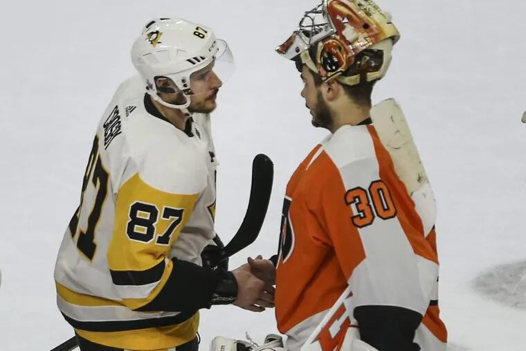 Goalie Michal Neuvirth shakes hands with Penguins captain Sidney Crosby at the end of their first-round series.