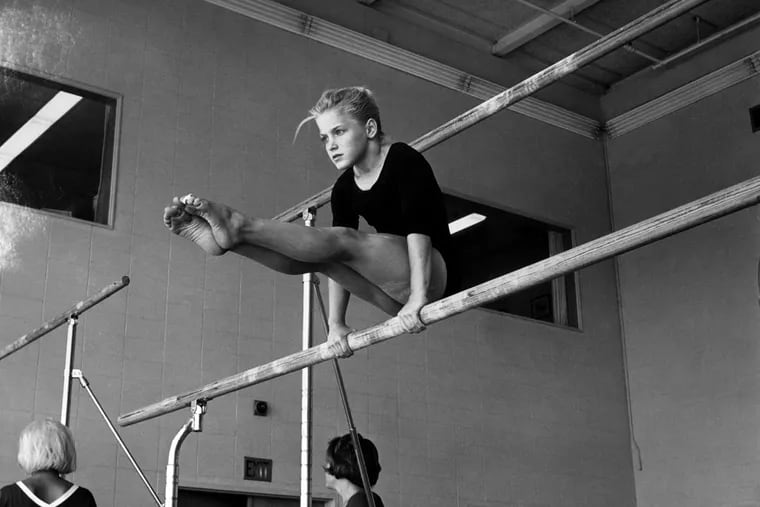 Hali Sheriff trains on uneven parallel bars at George Nissen's facility in 1966.