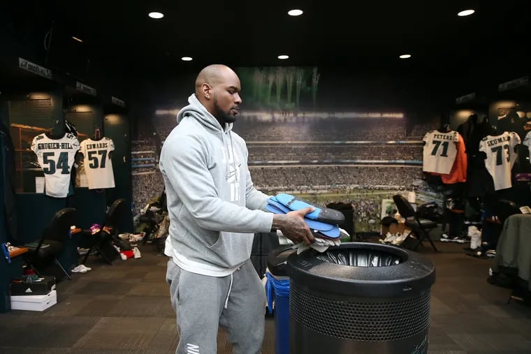 Eagles outside linebacker Nigel Bradham tosses a few items out as Eagles players clean out their lockers at the NovaCare Complex in January.