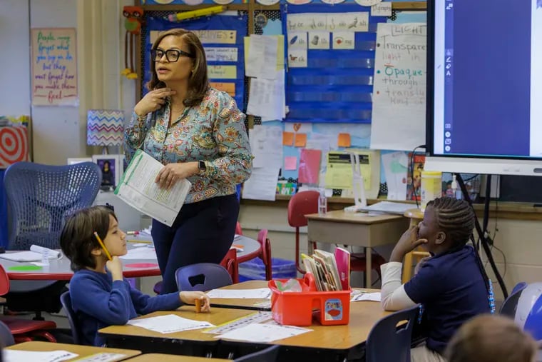 First-grade teacher Sandra Gimenez helps students sound out words during a lesson last month at Lingelbach Elementary School in Philadelphia.