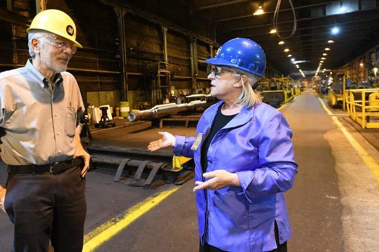 U.S. Rep. Susan Wild  (D., Pa.), right, speaks with James Romeo, president of Lehigh Heavy Forge, while touring the facility.