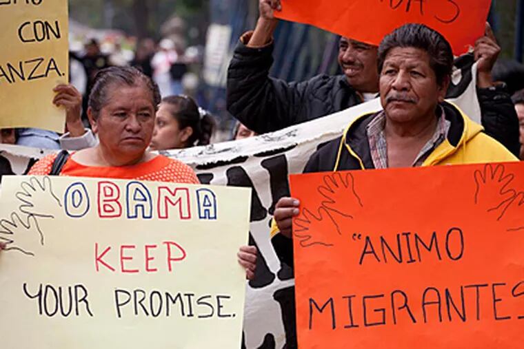 Migrants' rights activists hold signs, one reading in Spanish "Courage, migrants" outside the U.S. embassy on Obama's inauguration day, in Mexico City, Monday, Jan. 21, 2013. Protesters say Obama's administration has failed to address immigration promptly. (AP Photo/Eduardo Verdugo)