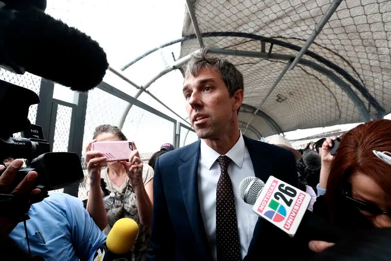 Democratic presidential candidate Beto O'Rourke is surrounded by reporters as he walks on an international bridge to cross into Ciudad Juarez, Mexico, Thursday, Aug. 8, 2019. O’Rourke has crossed the border into Mexico for the funeral of one of the 22 people killed in a mass shooting at a Walmart in El Paso, Texas.  (AP Photo/Christian Chavez)