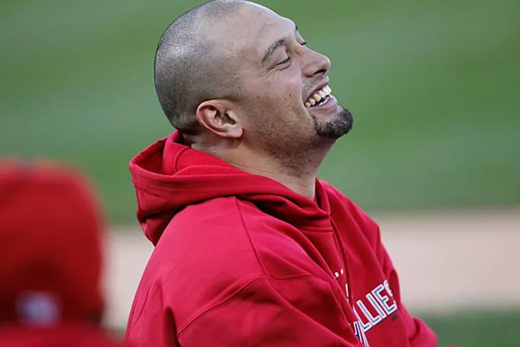 Shane Victorino laughs during stretching before Game 2 of the NLCS. (Michael Bryant / Staff Photographer)