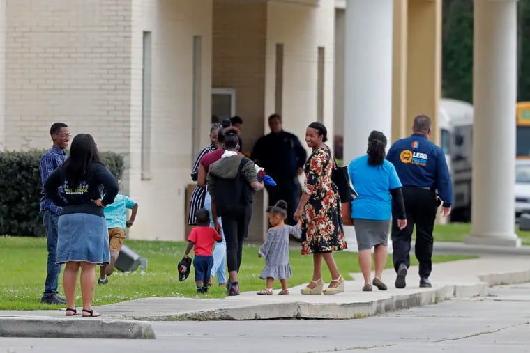 Congregants arrive at the Life Tabernacle Church in Central, La., Sunday, March 29, 2020. Pastor Tony Spell has defied a shelter-in-place order by Louisiana Gov. John Bel Edwards, due to the new coronavirus pandemic, and continues to hold church services with hundreds of congregants.