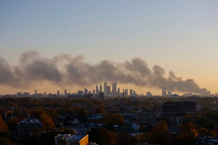 Smoke from tires and other debris on fire at Delaware Valley Recycling Inc. in Southwest Philadelphia on Tuesday blanketed the city.