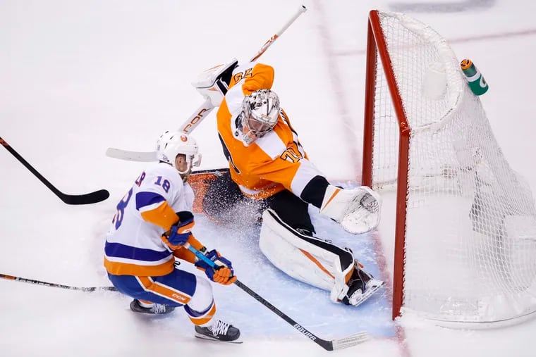 Flyers goaltender Carter Hart stops Islanders left winger Anthony Beauvillier during the first period Wednesday. The Flyers won in overtime, 4-3.