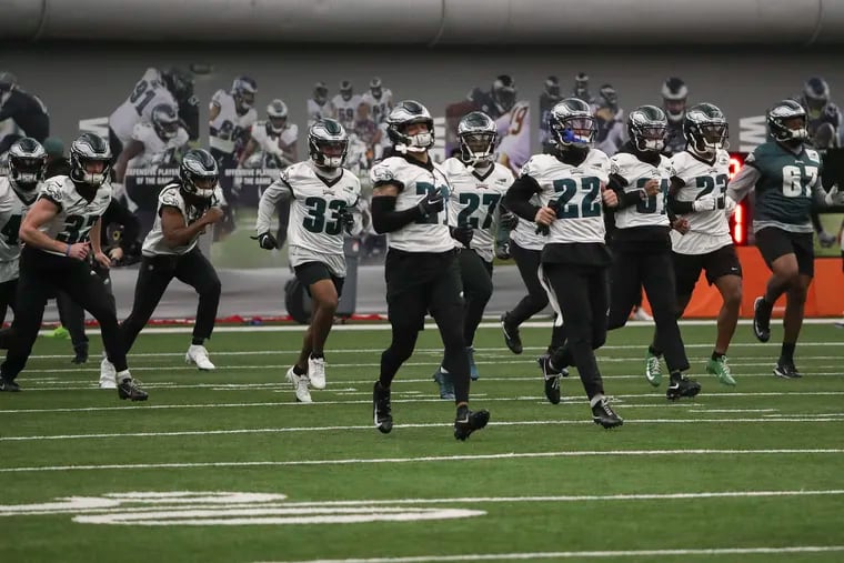 The Eagles warm up before the start of practice at the NovaCare Complex in Philadelphia on Friday, before departing for Arizona for Super Bowl LVII.