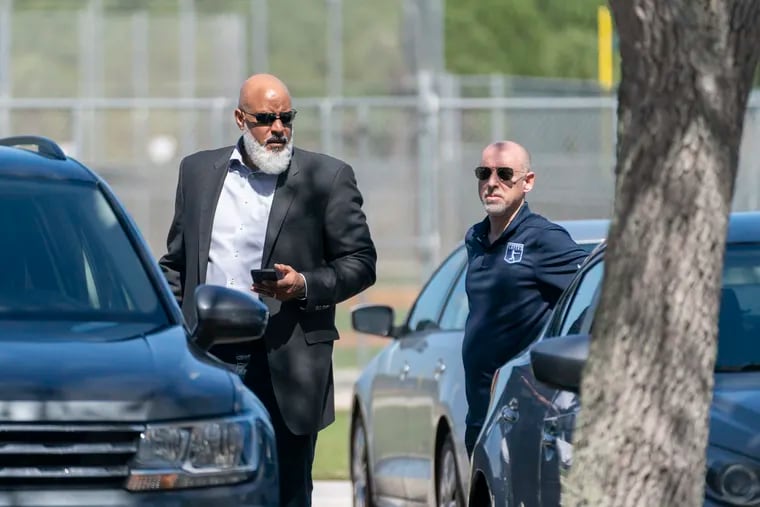 MLB Players Association executive director Tony Clark, left, and chief negotiator Bruce Meyer arrive for a collective bargaining session Wednesday at Roger Dean Stadium in Jupiter, Fla.