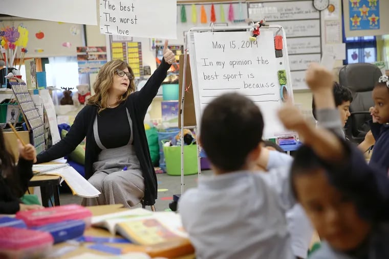 Gina Weightman gauges her kindergarten class with a thumbs-up at Anne Frank Elementary School in Northeast Philadelphia. Weightman is one of this year's Lindback Award winners.