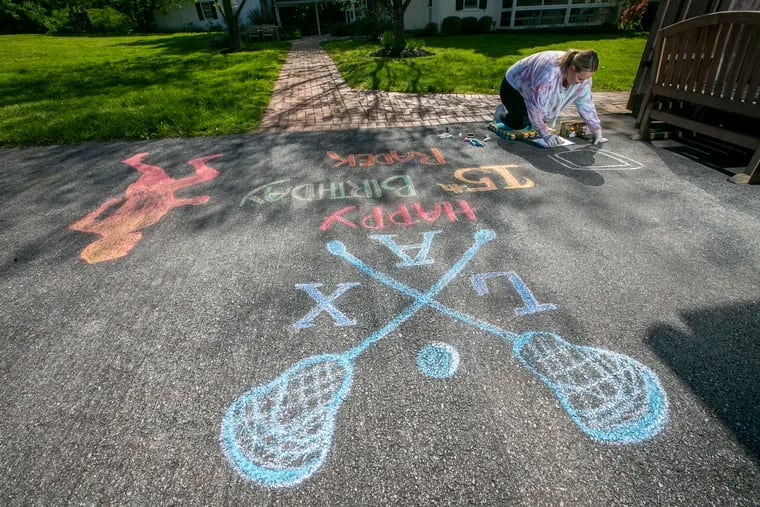 Stefanie Heron-Birl, former face painter now chalk drawer because of social distancing, creates a drawing on the driveway of Kate Semon's house on Allerton Road in West Chester. This drawing is for Radek Semon to help celebrate his 15th birthday.