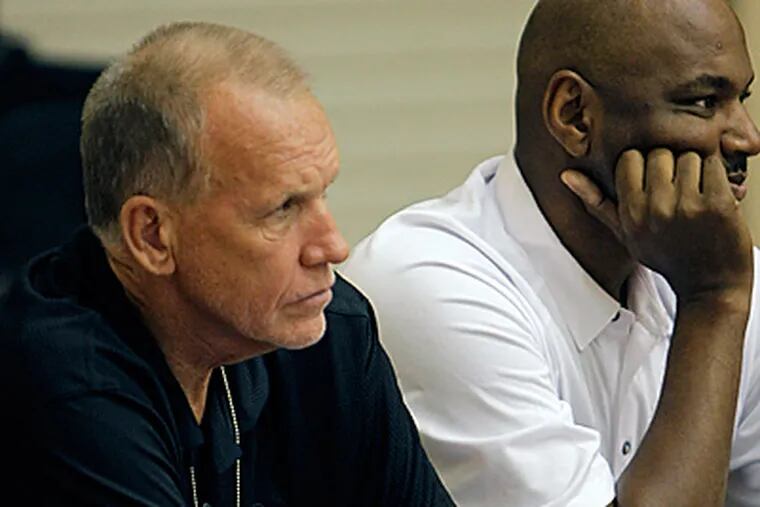 Doug Collins, left, and assistant coach Michael Curry watch the second half of yesterday's game. (AP Photo/John Raoux)