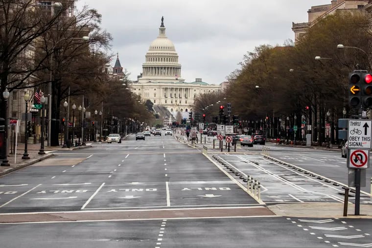 With the U.S. Capitol building in the background, motorists drive on Pennsylvania Avenue NW on Wednesday.