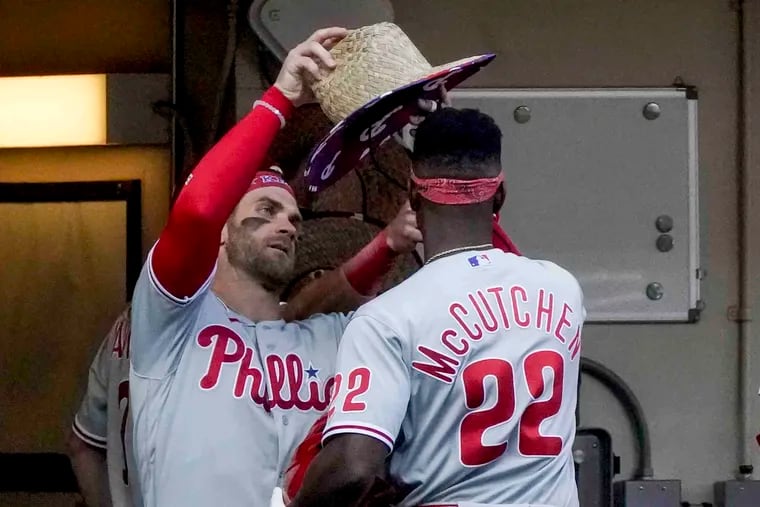 Bryce Harper put the Phillies' home-run hat on Andrew McCutchen's head after the latter went deep in Monday's 12-0 victory in Milwaukee.