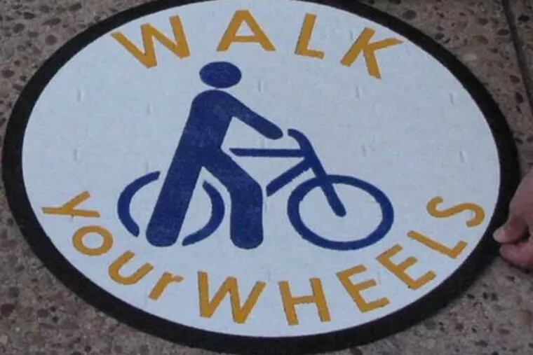 Riding a bike on the sidewalk is illegal. Here's a sign of the times.