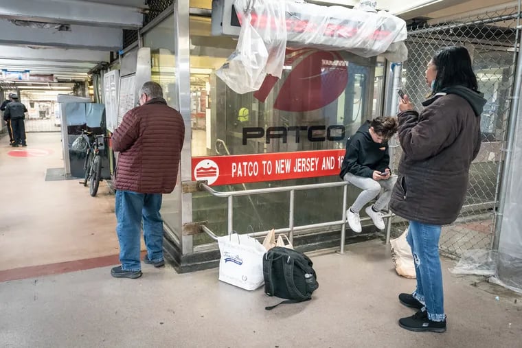 People wait at the 8th and Market PATCO station after service was suspended because of Friday's earthquake.