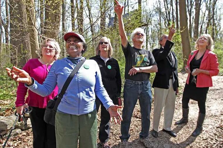 Members of the Alliance for the Presevation of the Wissahickon,  left to right, Denise Cotter, Carmella Clark, Susan Simon, Don Simon, Robert Epstein and Kris Soffa stand off the trail and look up where the zipline is suppose to be placed in Wiisahickon Park.  It is suppose to impact a 5 acre area of the park. The area will also have to be fenced in cutting off anilmals from using that part of the park. Wissahickon Park - Henry and Wigard.  ( MICHAEL BRYANT / Staff Photographer  )